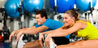 Couple Exercising Stretching at the Gym