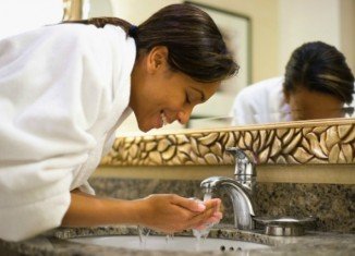 woman washing her face